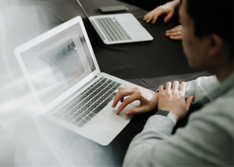 Zwei Personen arbeiten an Laptops